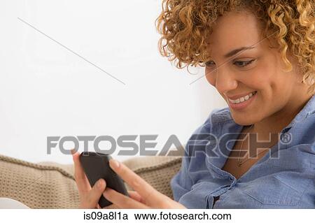 Woman using mobile phone, portrait View Large Photo Image Stock Image - Woman using mobile phone, portrait. Fotosearch