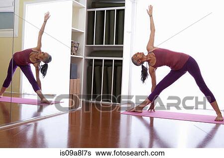 Woman with arm raised and touching floor View Large Photo Image Stock Photograph - Woman with arm raised and touching floor. Fotosearch