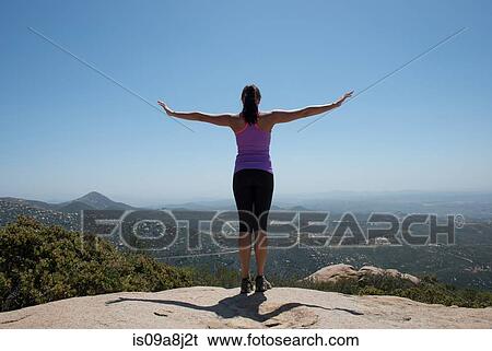 Stock Photograph - Woman with outstretched arms overlooking view of San Diego, California, USA. Fotosearch