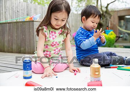 Young brother and sister painting and drawing in garden View Large Photo Image Stock Image - Young brother and sister painting and drawing in garden. Fotosearch