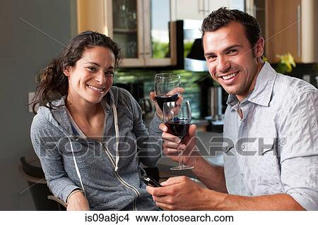 Young couple enjoying wine at home, portrait View Large Photo Image Picture - Young couple enjoying wine at home, portrait. Fotosearch