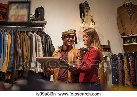 Young couple in vintage clothes shop View Large Photo Image Picture - Young couple in vintage clothes shop. Fotosearch