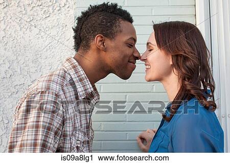 Young couple touching noses View Large Photo Image Stock Image - Young couple touching noses. Fotosearch