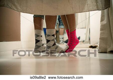 Young couple wearing socks in changing room, low section View Large Photo Image Stock Image - Young couple wearing socks in changing room, low section. Fotosearch
