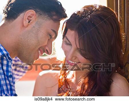 Picture - Young couple with woman smiling, close up. Fotosearch