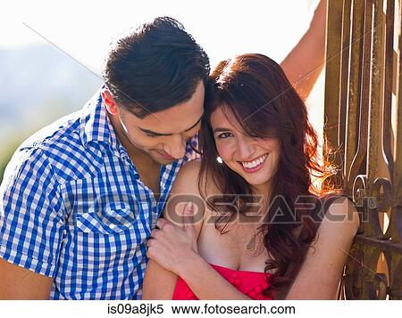 Stock Photography - Young couple with woman smiling, portrait. Fotosearch