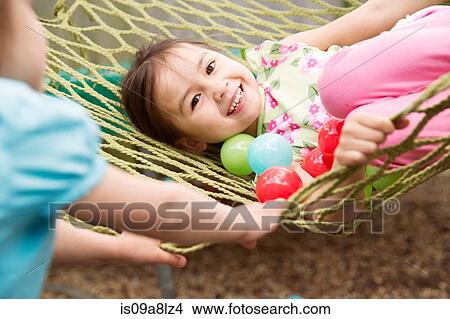 Young girl in hammock with colored balls View Large Photo Image Picture - Young girl in hammock with colored balls. Fotosearch