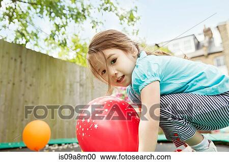Young girl playing in garden with balloons View Large Photo Image Stock Image - Young girl playing in garden with balloons. Fotosearch