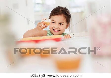 Young girl with fairy cake View Large Photo Image Stock Photo - Young girl with fairy cake. Fotosearch