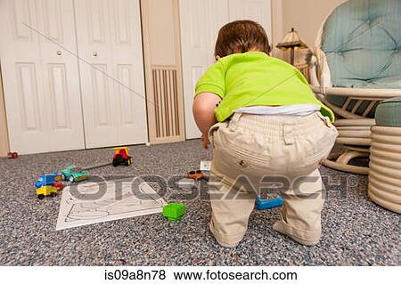 Young male toddler playing with toys View Large Photo Image Stock Photo - Young male toddler playing with toys. Fotosearch