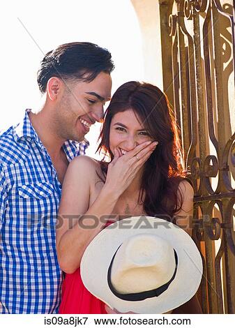 Young man looking at woman giggling, portrait View Large Photo Image Stock Photo - Young man looking at woman giggling, portrait. Fotosearch