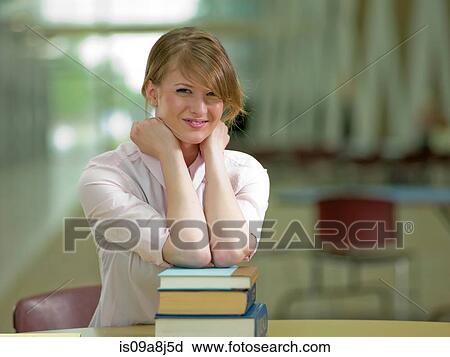 Young student leaning on school books, portrait View Large Photo Image Stock Image - Young student leaning on school books, portrait. Fotosearch