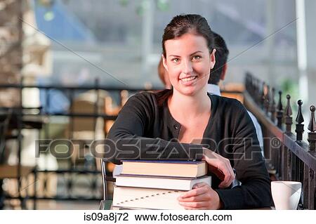 Young student leaning on stack of books, portrait View Large Photo Image Stock Image - Young student leaning on stack of books, portrait. Fotosearch