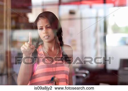 Young woman drawing on window of diner View Large Photo Image Stock Image - Young woman drawing on window of diner. Fotosearch