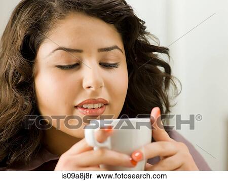 Young woman drinking from cup, close up View Large Photo Image Stock Photography - Young woman drinking from cup, close up. Fotosearch