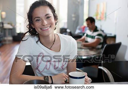 Young woman enjoying coffee in kitchen, portrait View Large Photo Image Stock Photograph - Young woman enjoying coffee in kitchen, portrait. Fotosearch