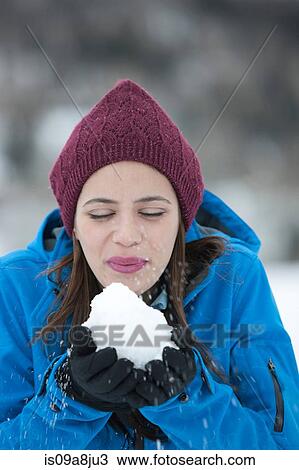 Young woman holding snowball, close up View Large Photo Image Stock Image - Young woman holding snowball, close up. Fotosearch