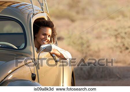 Young woman sitting in car, portrait View Large Photo Image Stock Image - Young woman sitting in car, portrait. Fotosearch