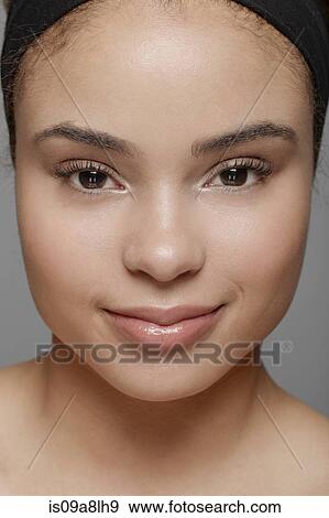 Young woman smiling at camera View Large Photo Image Stock Photo - Young woman smiling at camera. Fotosearch