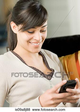 Young woman using mobile phone View Large Photo Image Stock Photo - Young woman using mobile phone. Fotosearch