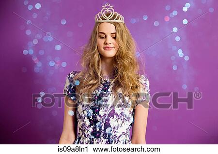 Stock Image - Young woman wearing tiara with glitter. Fotosearch