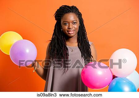Stock Image - Young woman with balloons. Fotosearch