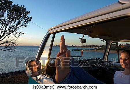 Young woman with feet up on camper van window View Large Photo Image Stock Image - Young woman with feet up on camper van window. Fotosearch
