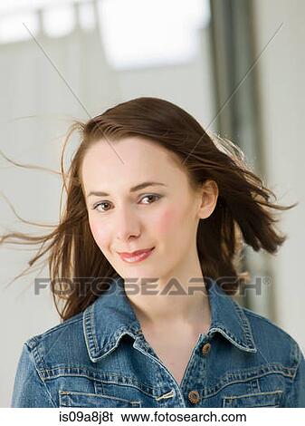 Young woman with windswept hair, portrait View Large Photo Image Stock Photograph - Young woman with windswept hair, portrait. Fotosearch