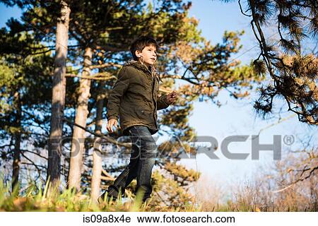 Boy walking in countryside View Large Photo Image Stock Image - Boy walking in countryside. Fotosearch