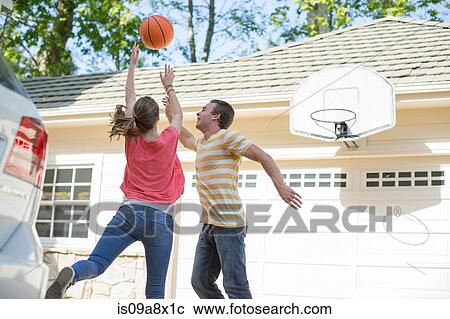 Brother and sister playing basketball View Large Photo Image Stock Image - Brother and sister playing basketball. Fotosearch
