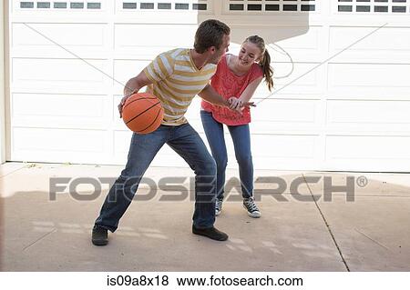 Brother and sister playing basketball View Large Photo Image Stock Photo - Brother and sister playing basketball. Fotosearch
