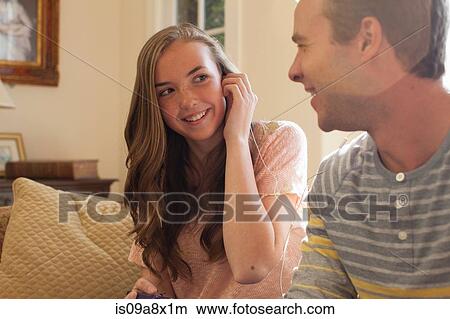 Picture - Brother and sister with earphones. Fotosearch