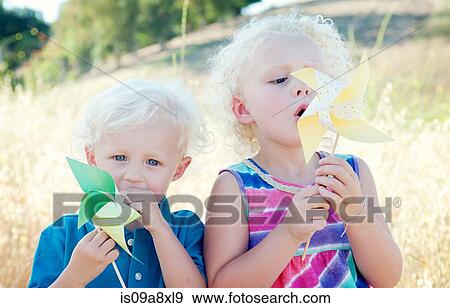 Stock Photo - Brother and sister with pinwheels. Fotosearch