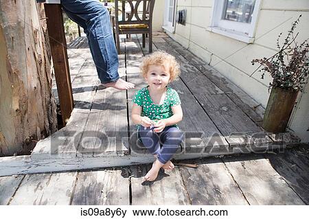 Stock Photo - Child sitting cross legged. Fotosearch