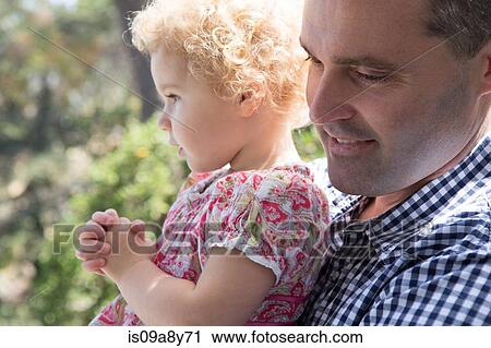 Close up of father carrying child View Large Photo Image Stock Image - Close up of father carrying child. Fotosearch