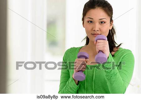 Close up of woman punching with dumbbells in hand View Large Photo Image Stock Photography - Close up of woman punching with dumbbells in hand. Fotosearch
