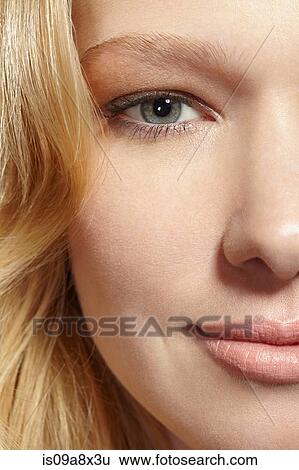 Stock Photograph - Close-up portrait of blonde woman looking at camera. Fotosearch