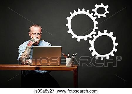 Stock Photo - Conceptual image of man as cog in the wheel. Fotosearch