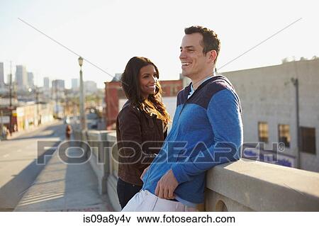 Couple chatting on bridge View Large Photo Image Stock Photo - Couple chatting on bridge. Fotosearch