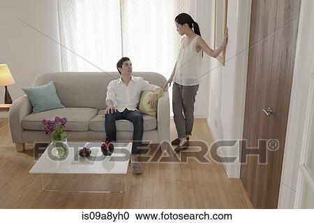 Stock Image - Couple discussing in living room. Fotosearch