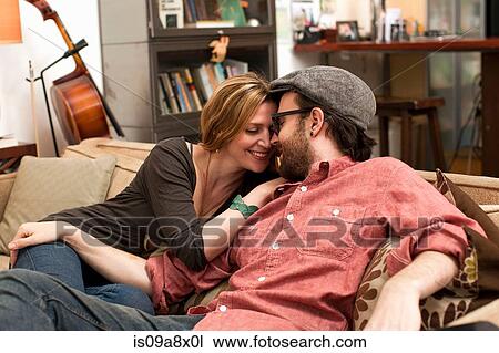Couple kissing on sofa View Large Photo Image Stock Image - Couple kissing on sofa. Fotosearch
