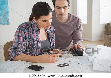 Couple looking at home finances View Large Photo Image Stock Photo - Couple looking at home finances. Fotosearch