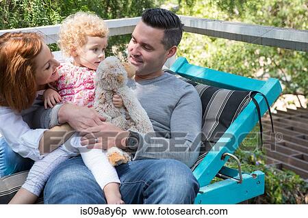 Couple on deckchair with child View Large Photo Image Stock Photography - Couple on deckchair with child. Fotosearch