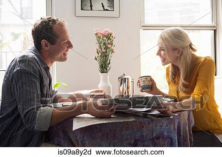Stock Image - Couple reading papers together. Fotosearch