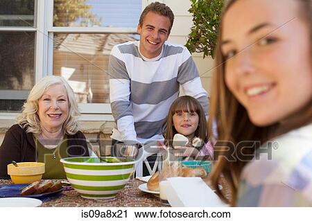 Family having breakfast outdoors View Large Photo Image Stock Image - Family having breakfast outdoors. Fotosearch