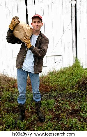 Farmer with sack of feed on shoulder View Large Photo Image Stock Photo - Farmer with sack of feed on shoulder. Fotosearch