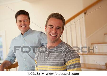 Stock Photo - Father and adult son, laughing. Fotosearch
