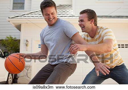 Picture - Father and adult son playing basketball. Fotosearch
