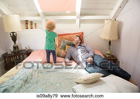 Father and child looking at ceiling View Large Photo Image Stock Photo - Father and child looking at ceiling. Fotosearch