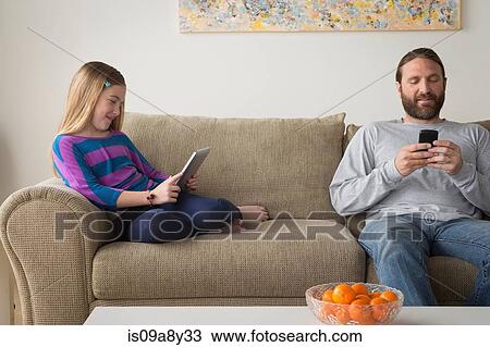 Father and daughter sitting on couch View Large Photo Image Stock Image - Father and daughter sitting on couch. Fotosearch